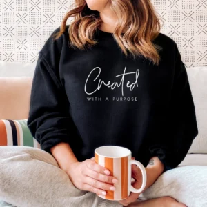 A woman sitting on the couch holding a coffee mug.