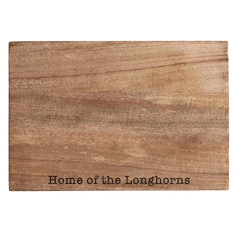 A wooden cutting board with the words " home of the longhorns ".