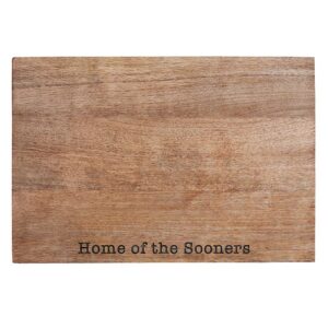 A wooden cutting board with the words " home of the sooners ".