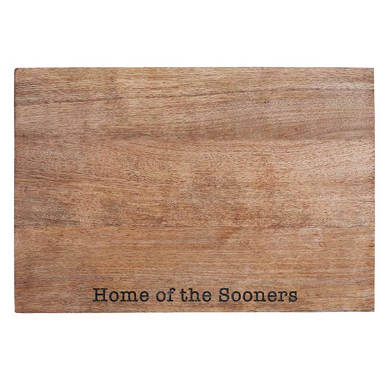 A wooden cutting board with the words " home of the sooners ".