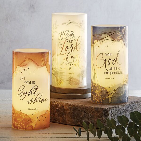 A group of three candles with the words " let your light shine ".