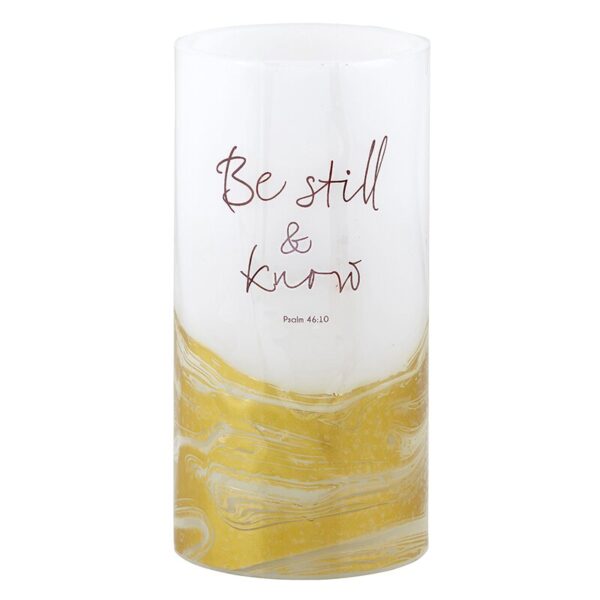 A candle that has the words " be still and know."