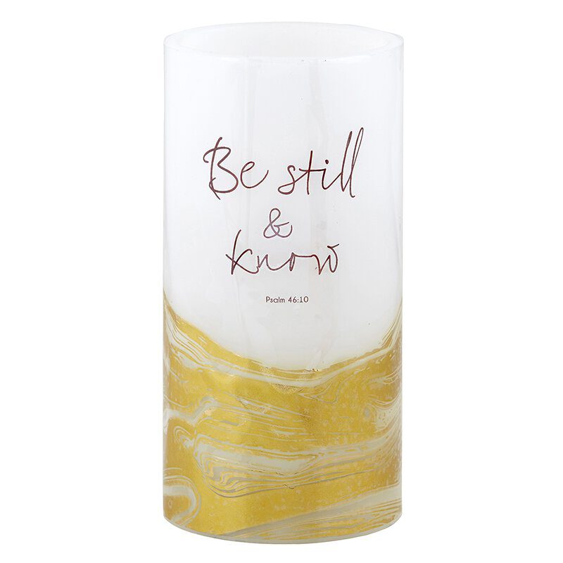 A candle that has the words " be still and know."