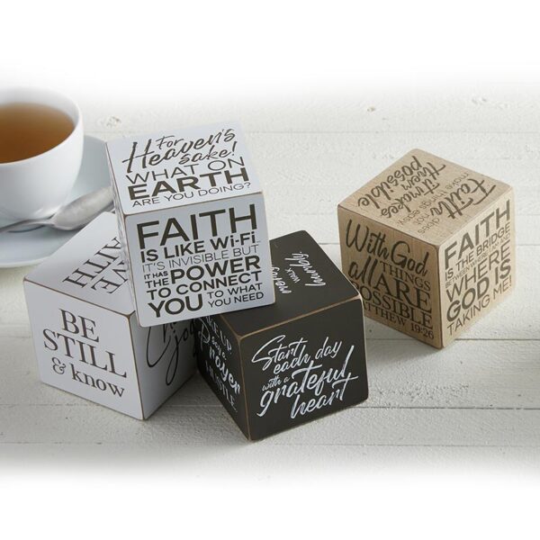 A group of four wooden blocks with bible verses.