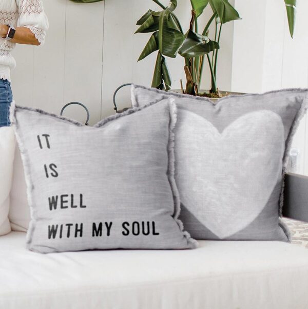 Two pillows with a heart and words on them.