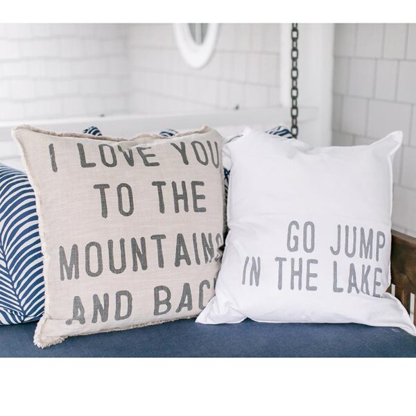 Two pillows with words on them sitting next to each other.