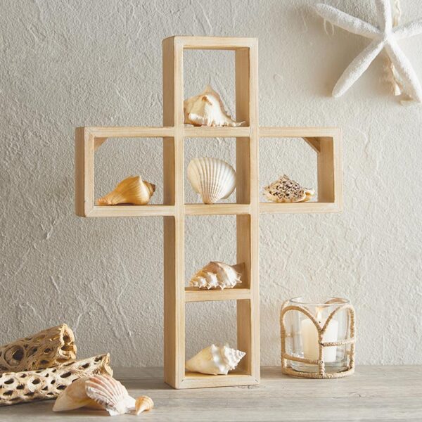 A cross shaped shelf with shells on top of it.