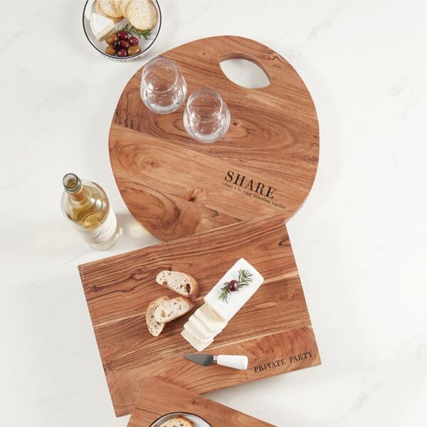 A couple of wooden cutting boards on top of a table.