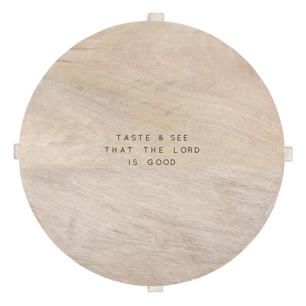 A wooden plate with the words " taste & eat, that the lord is good ".