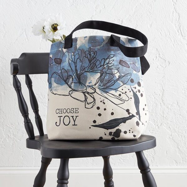 A black chair with a white flower and blue bag