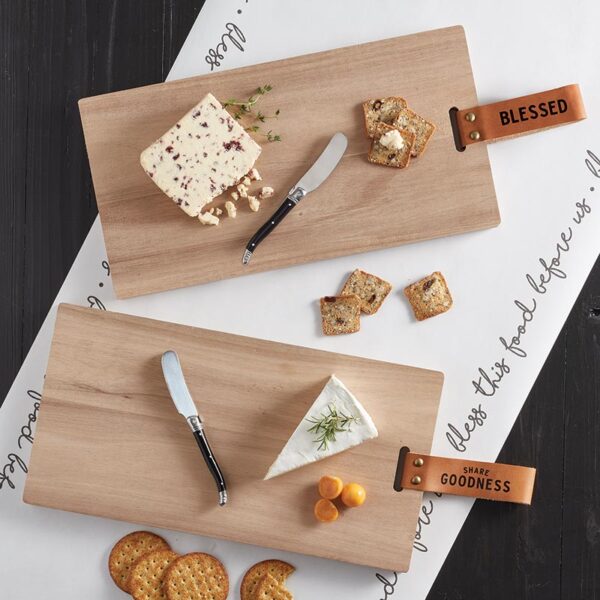 Two cutting boards with cheese and crackers on them.