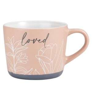 A pink mug with the word " loved " written on it.