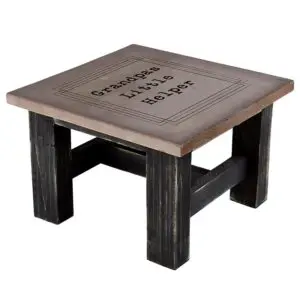 A table with a wooden top and black legs.