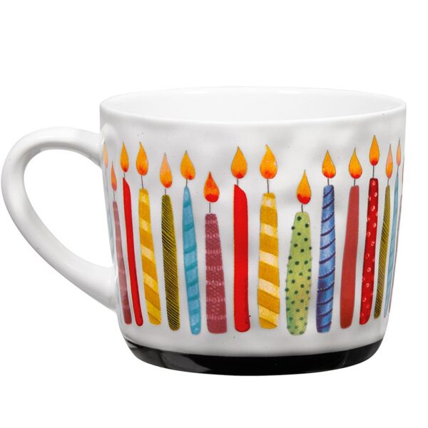 A white coffee mug with candles on it.