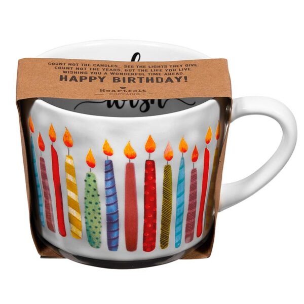 A coffee mug with candles on it.