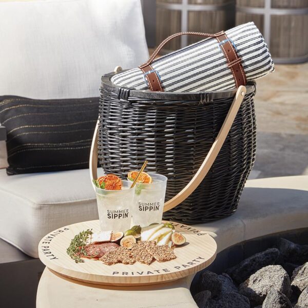 A basket with food and drink on top of it.