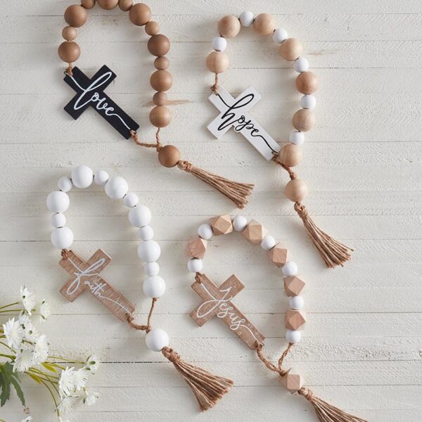 A group of four wooden rosary beads with crosses.