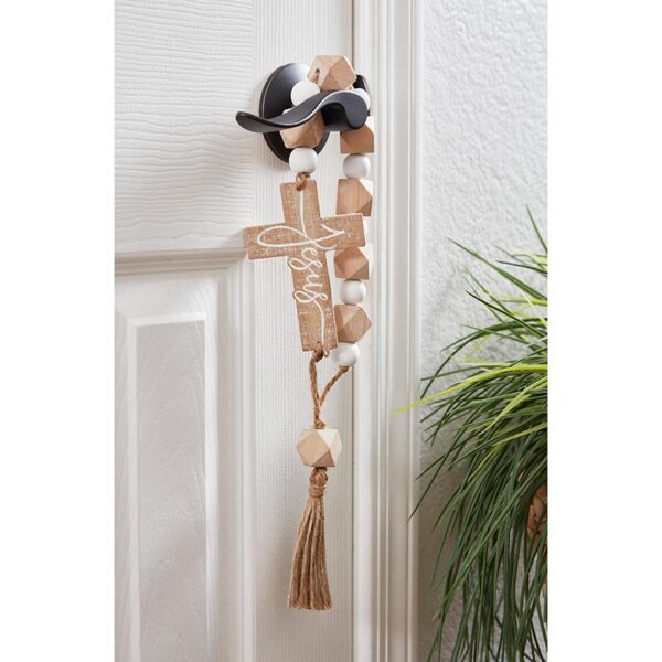 A door with a cross and birds hanging on it.