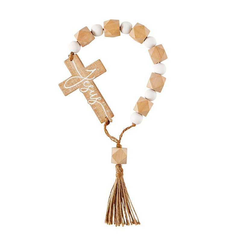 A wooden cross with white beads and tassel.