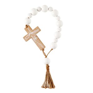 A wooden cross with white beads hanging from it.