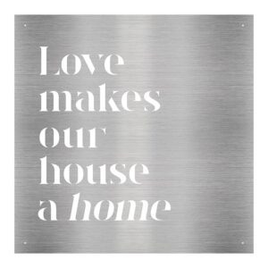 A metal sign that says love makes our house a home.