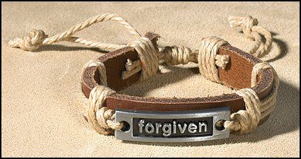 A leather bracelet with the word forgiven on it.