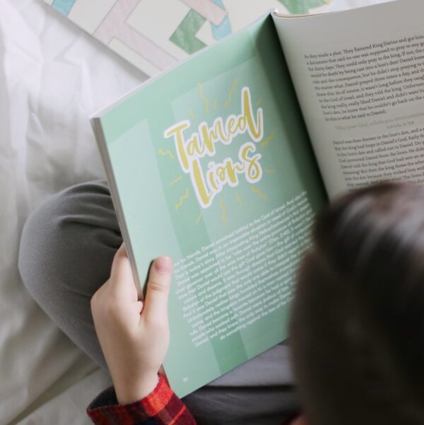 A person reading a book on the bed