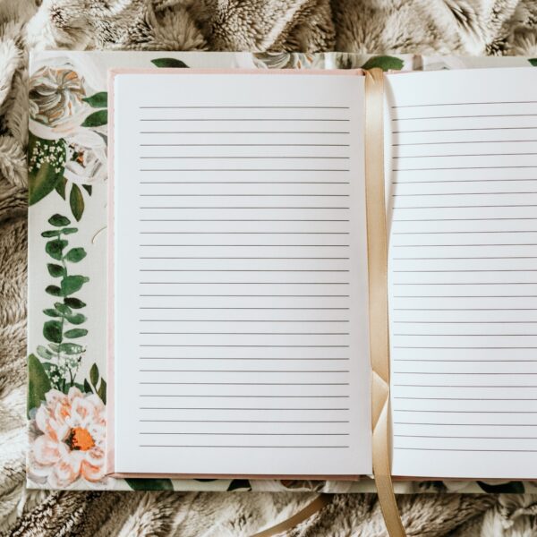 A notebook with lined paper and floral design.