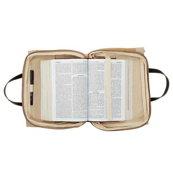 A bible is open to the pages of an old testament.