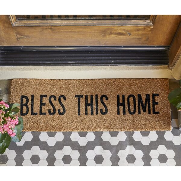 A welcome mat that says " bless this home ".