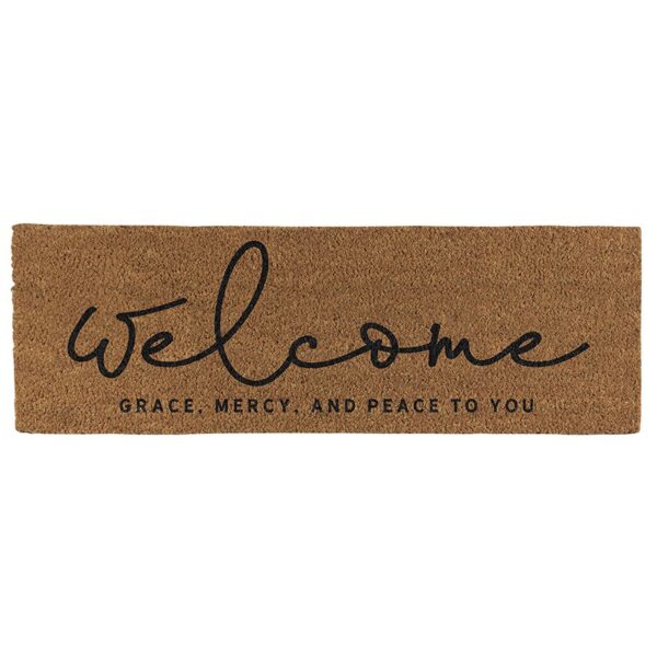 A welcome mat with the word " welcome " written in black ink.