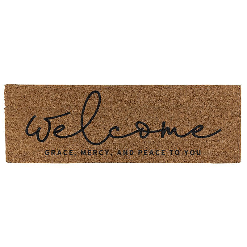 A welcome mat with the word " welcome " written in black ink.