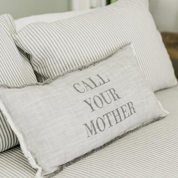 A pillow that says " call your mother ".