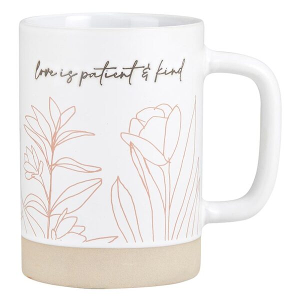 A coffee mug with the words love is patient and kind on it.