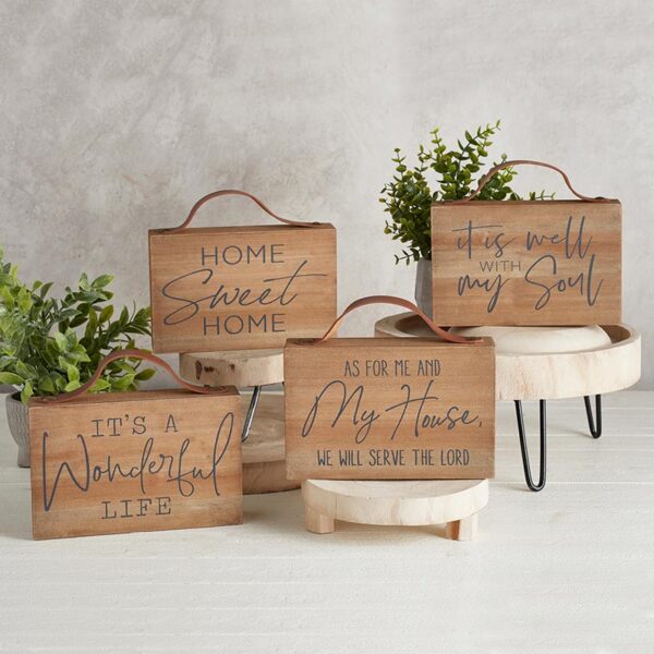 A group of four wooden boxes with plants inside.