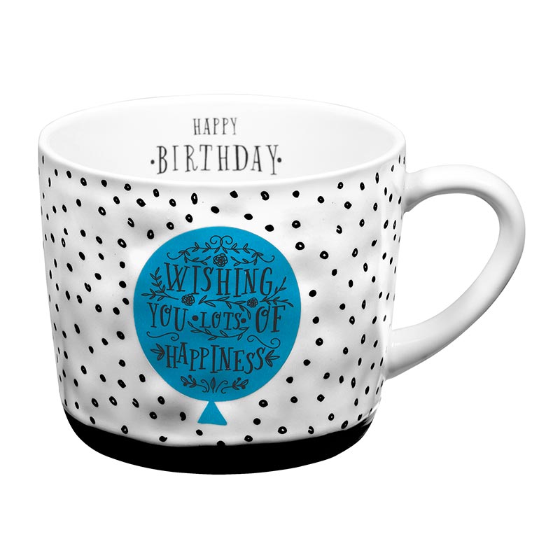 A white mug with black dots and blue lettering.