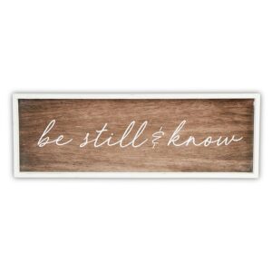 A wooden sign with the words " be still and know ".