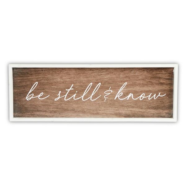 A wooden sign with the words " be still and know ".