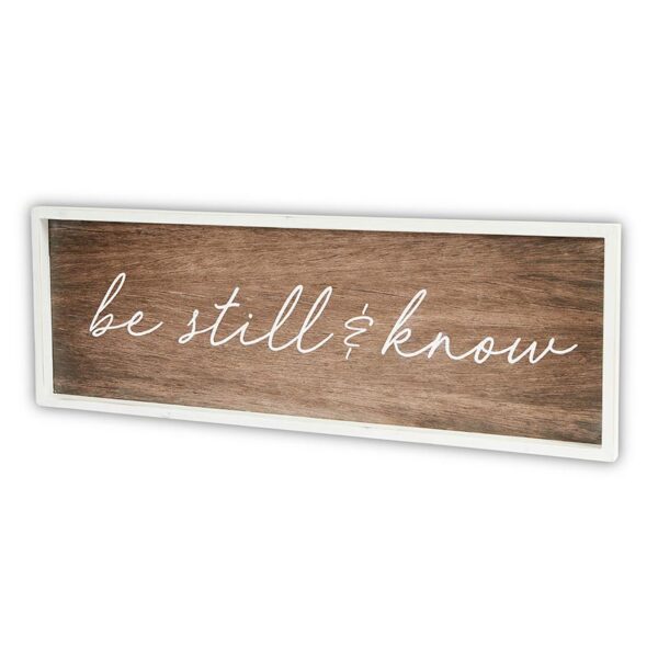 A wooden sign with the words " be still and know ".