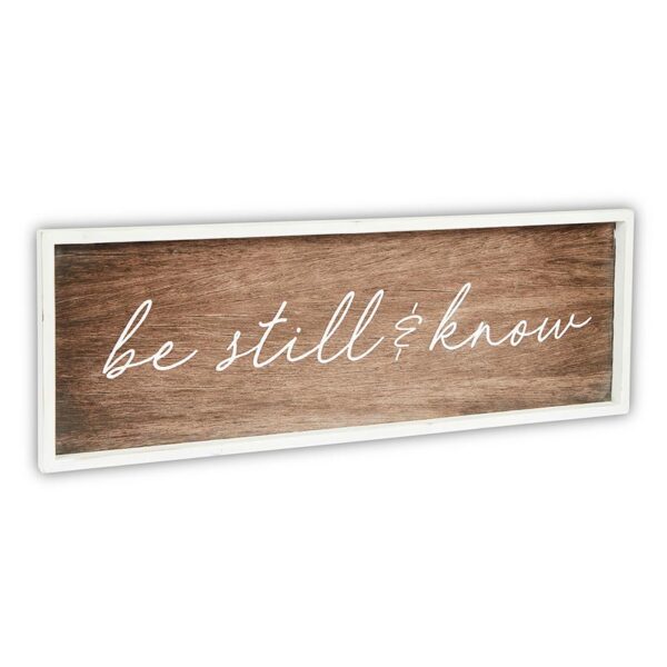 A wooden sign with the words " be still & know ".