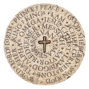 A round stone with words and cross on it.