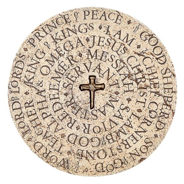 A round stone with words and cross on it.