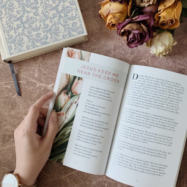 A person reading a book on the table